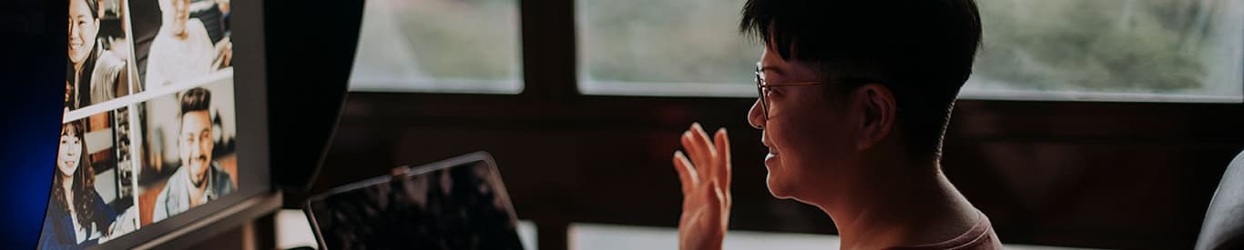 woman waving to video conference call participants