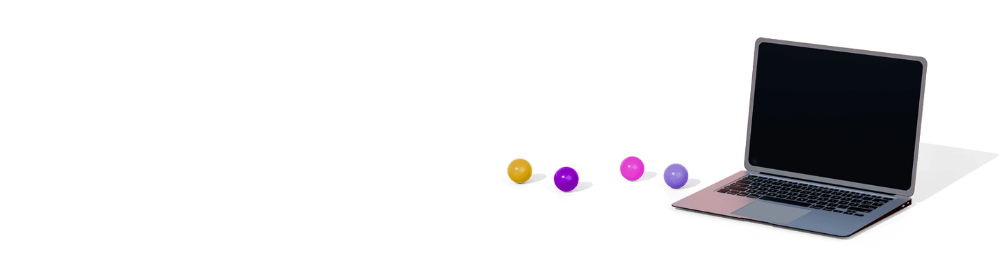 Laptop device with multicolored balls next to it